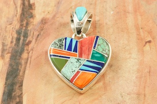 Genuine Turquoise, Spiny Oyster Shell and Blue Lapis inlaid between ribbons of Sterling Silver. Free 18" Sterling Silver Chain with Purchase of Pendant. Beautiful Pendant Created by Navajo Artist Calvin Begay. Signed